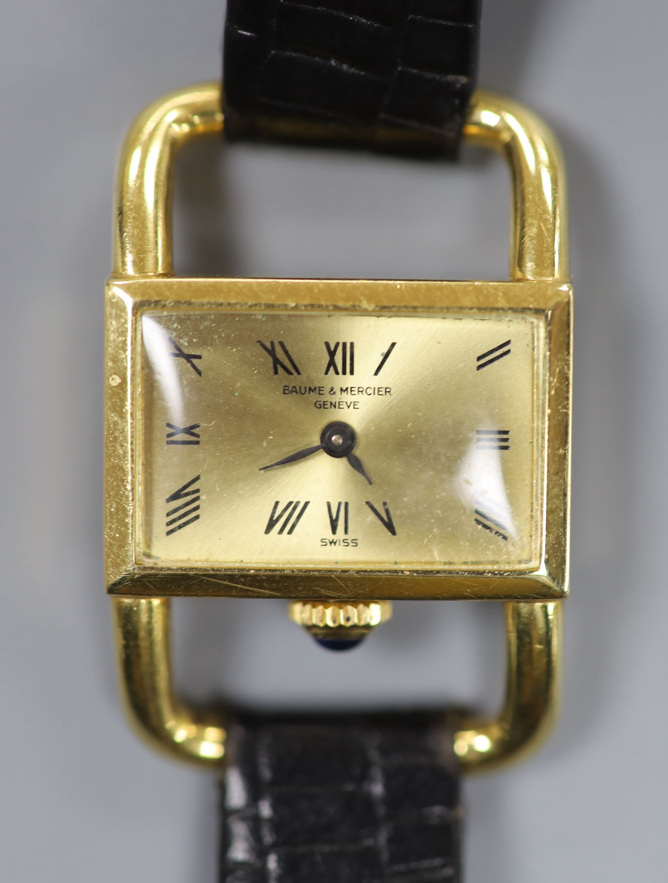 A ladys modern 750 yellow metal Baume & Mercier manual wind rectangular dress wrist watch, on a leather strap (strap a.f.),